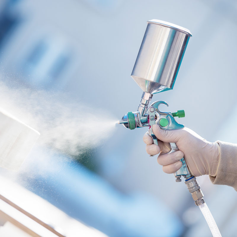 man holding commercial spray gun